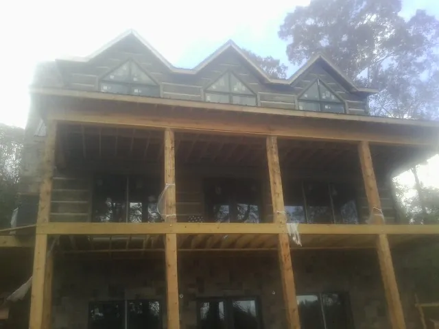 Dormers and porch framing on a large log home under construction — Roof Coating work by our crew in Veedersburg