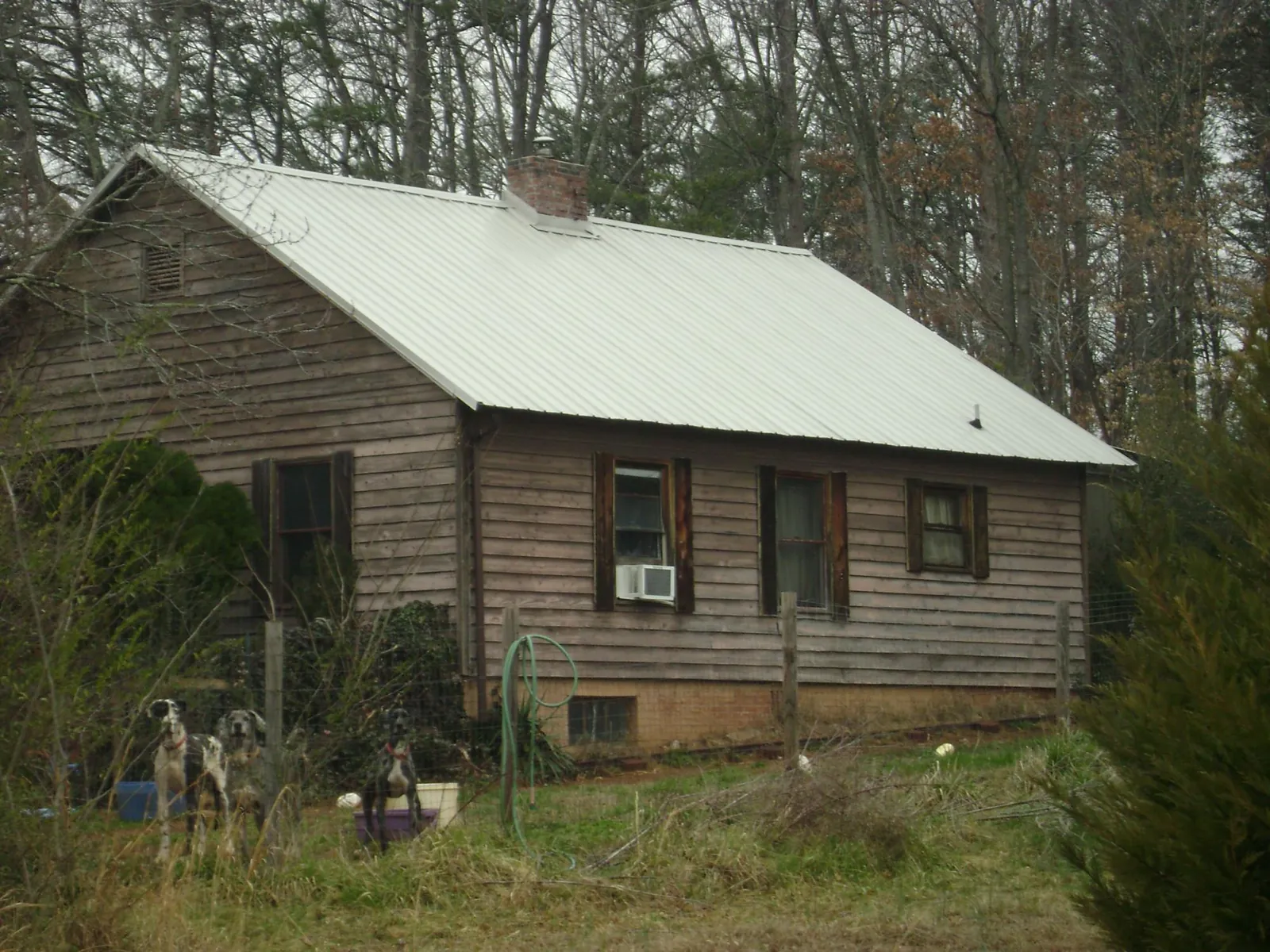 White metal roof on an old wood sided farmhouse, from a Metal Roof Installation job in Veedersburg